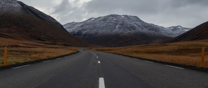 An empty road heading into the mountains.