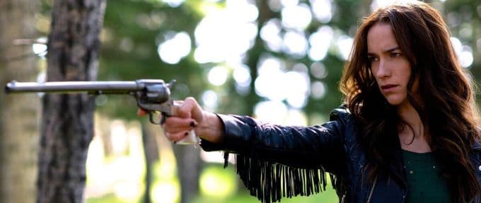 Wynonna Earp holding her magic gun, Peacemaker.