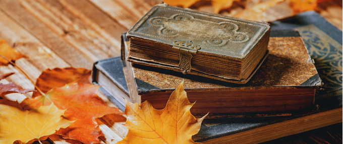 photo of old books with colorful autumn leaves