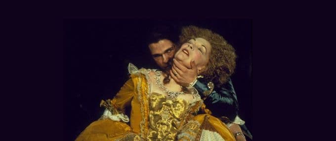 brad pitt dressed as a vampire, attacking a woman in period dress.